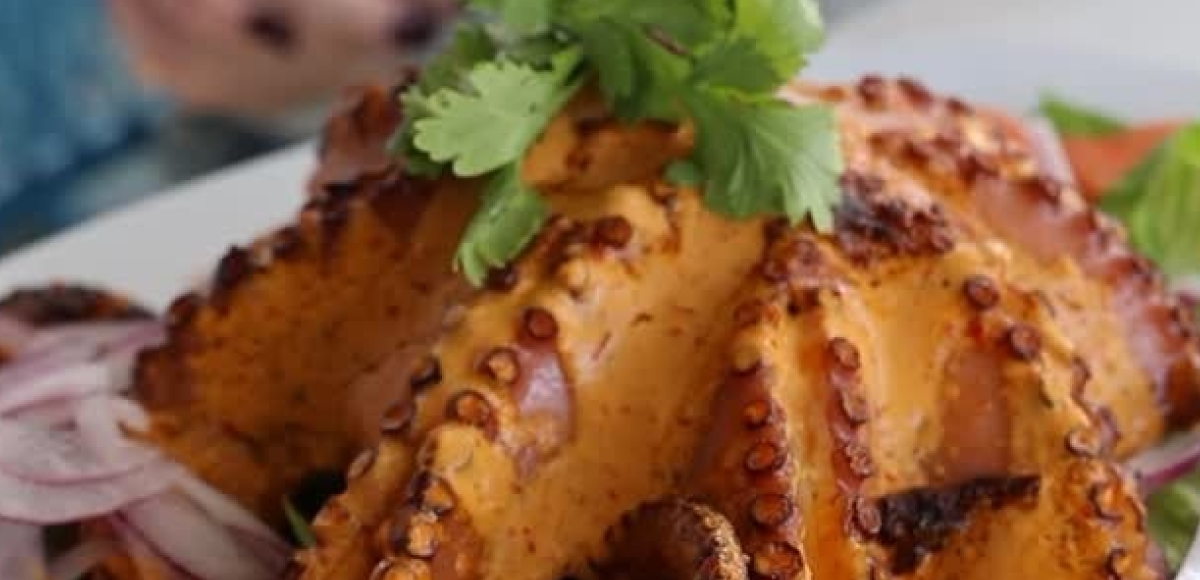 Tender grilled octopus with cilantro and onions served at Makai Seafood Market, San Diego.